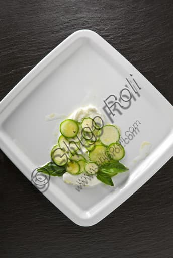 Fresh summer plate with mozzarella, sliced zucchini and fresh basil leaves