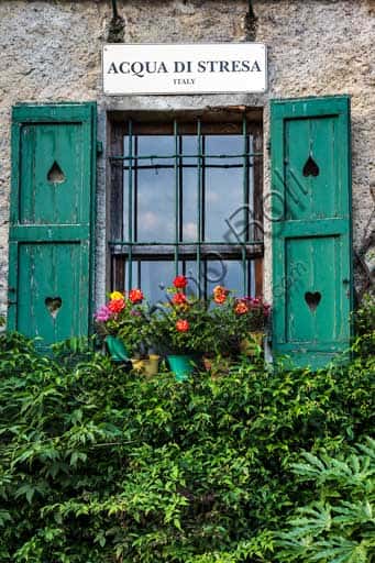 Isola Pescatori: View of the Village with Window, Flowers and Sign