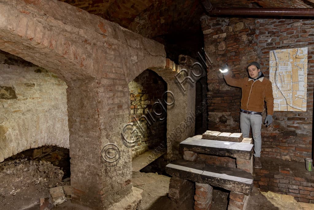 Andrea Busi, president of Brescia Underground, explores the historic basements under the Clock Tower in Brescia
