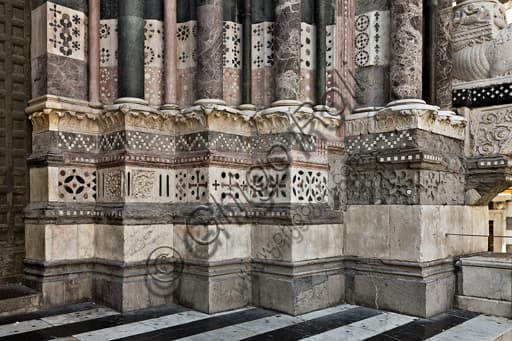 Detail of the bases of the right doorway, west facade of St. Lawrence Cathedral in Genoa, Liguria, Italy