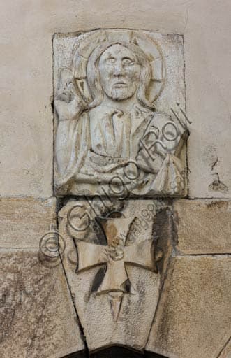 Stone or wooden relief with Blessing Christ, sculptural detail from the Collegiate Church of St. Gervasius and Protasius in Bormio, Valtellina, Italy.