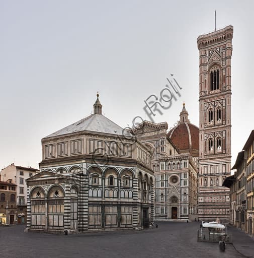 South-Western façade of the Baptistery of St. John in Florence, white and green marble with Andrea Pisano's door, Duomo and Giotto's bell tower in background.