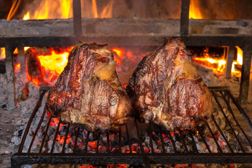 Traditional Florentine Steak, a thick cut of Tuscan barbecued beef, grilled and served rare.