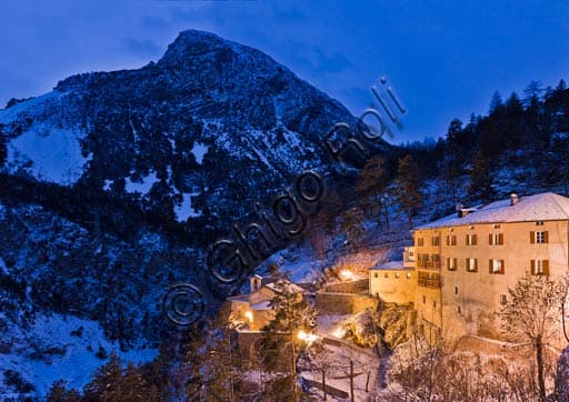Night view of Bagni Vecchi thermal bath complex in Bormio, evening lighting on historic architecture