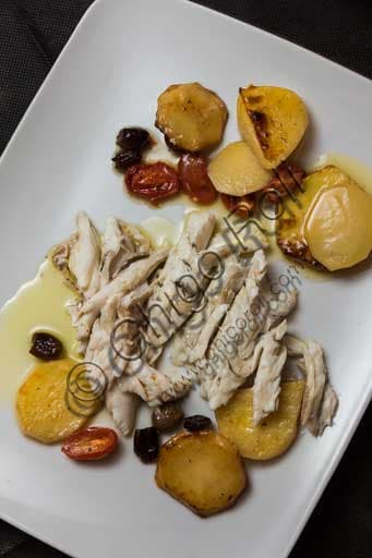 Baked sea bass with potatoes tomatoes and olives served at Al Graspo de Ua restaurant in Venice