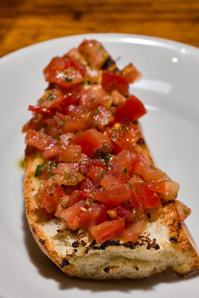 traditional tuscan tomato bruschetta on a wooden board