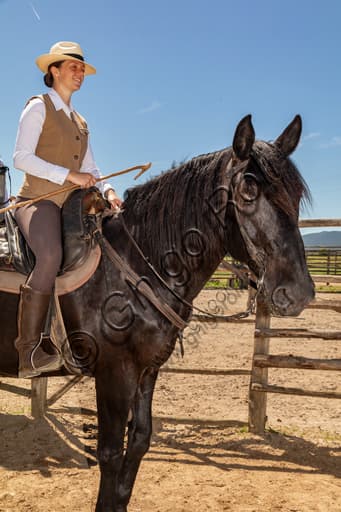 Buttero on horseback in the landscape of Maremma Regional Park, Tuscany Italy