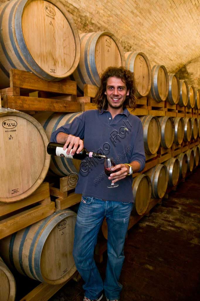 Guardigli, owner of Scacciadiavoli Winery, among the barrels of Montefalco Sagrantino in the Cantinone locality