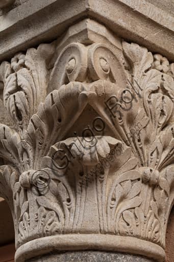 Sculptural detail of a face on a medieval Corinthian capital, Ghirlandina Tower, Modena
