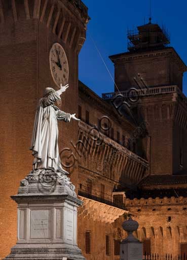 Ferrara, night view of the Estense Castle with the Girolamo Savonarola statue in the foreground