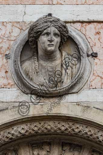 Detail of Ferrara Cathedral's façade showing the Roman female bust known as Madonna of Ferrara