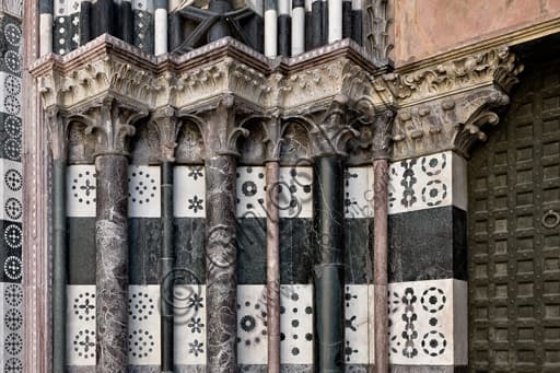 Detail of the columns of the left doorway, west façade of St. Lawrence Cathedral in Genoa, Italy