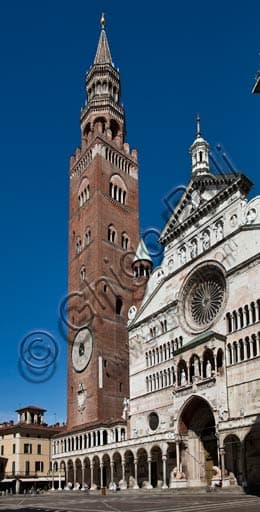 Panoramic view of Piazza del Comune in Cremona with the facade of the Cathedral and the imposing Torrazzo bell tower in the foreground