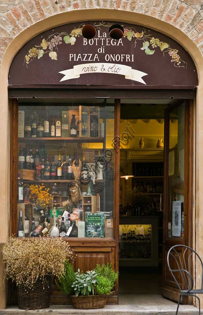 Inside view of Bottega di Piazza Onofri wine shop and restaurant in Bevagna showcasing wine bottles and tasting area