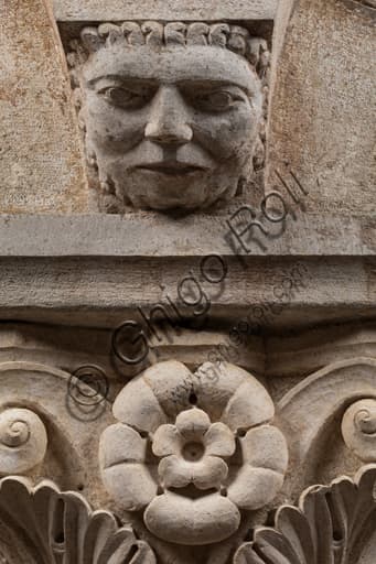 Detail of the sculpted face on the Corinthian capital, Ghirlandina Tower, Modena