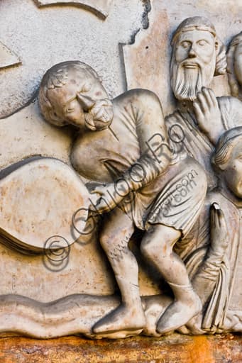 Sculptural detail of the tormenter with bellows, lunette of the Martyrdom of St. Lawrence, Genoa Cathedral main portal (c. 1225)