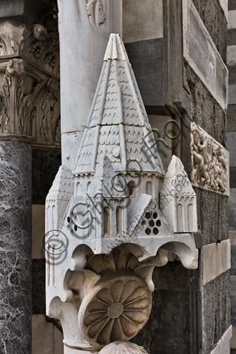 Top detail of the medieval Knife Grinder saint sculpture, St. Lawrence Cathedral Genoa facade