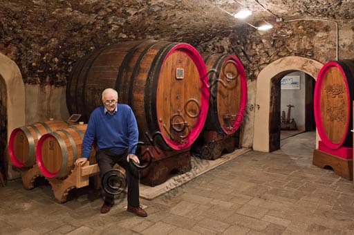 Egidio Tarantola Peloni in the Peloni Distillery cellars beside the ageing barrels for Braulio tonic liquor