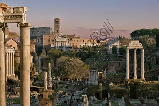 View of the Roman Forum in Rome showing the Temple of Saturn, the three columns of the Temple of Castor, and the Colosseum in the background