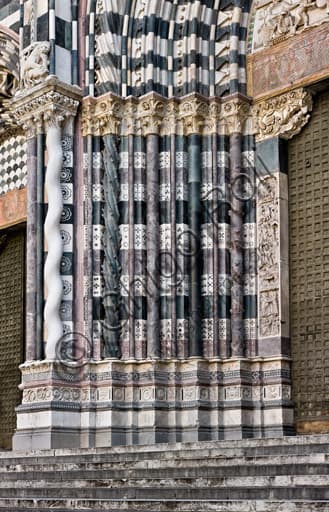 Architectural detail of the bases and columns of the main doorway of St. Lawrence Cathedral in Genoa
