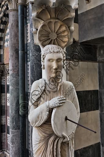 Sculptural detail of the saint with sundial figure, known as the Knife Grinder, corner of St. Lawrence Cathedral facade, Genoa