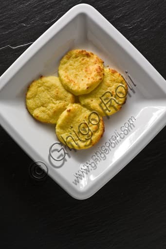 A baked plate of traditional Gnocchi alla Romana, a classic Italian semolina dish
