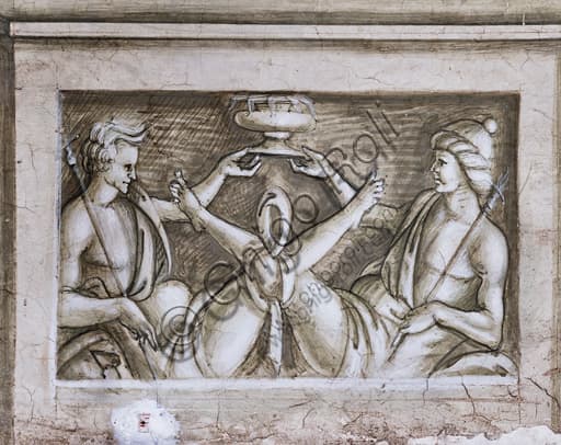 Dettaglio grisaille rinascimentale nella Libreria Piccolomini di Siena: due figure maschili legate reggono una coppa, basamento del pilastro.