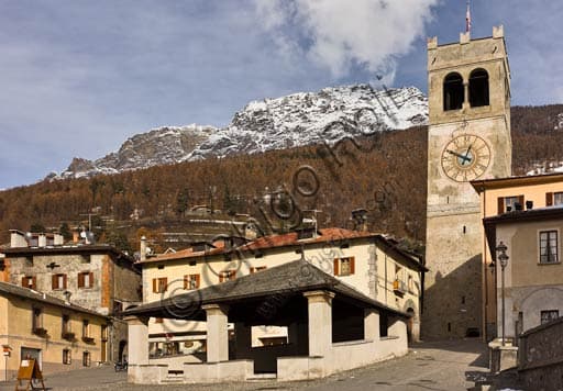 View of the historical Kuerc monument and the People's Tower with Baiona bell in Bormio