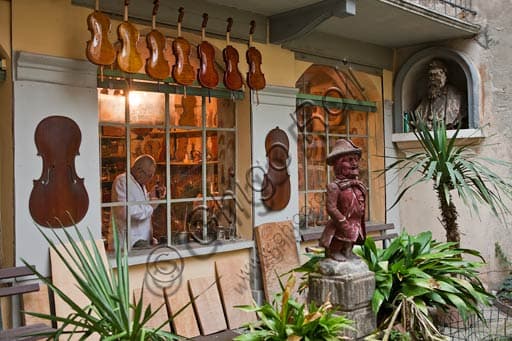 Stefano Conia's luthier workshop in Cremona, Italy, showing violin making tools and instruments