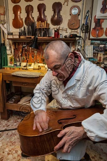 Stefano Conia the Elder in his luthier workshop in Cremona, Italy, among woods and violins
