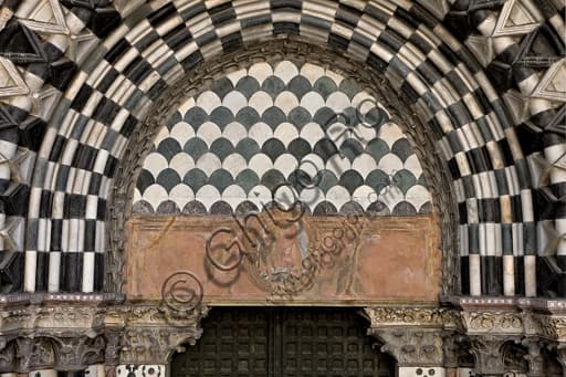 Sculpted lunette Virgin with Child between angels, right doorway St. Lawrence Cathedral Genoa