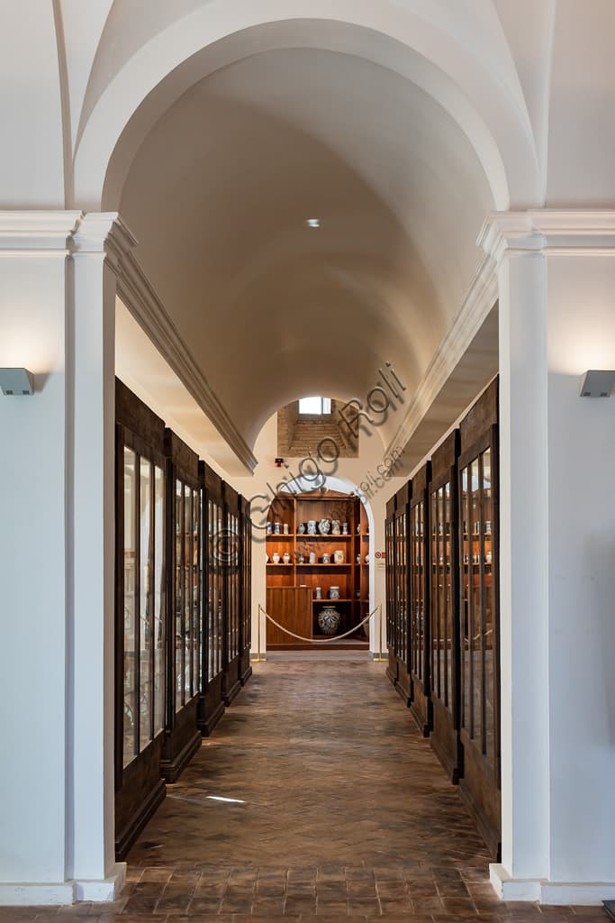 View of the exhibition corridor with display cabinets inside the Regional Ceramics Museum of Deruta, Italy