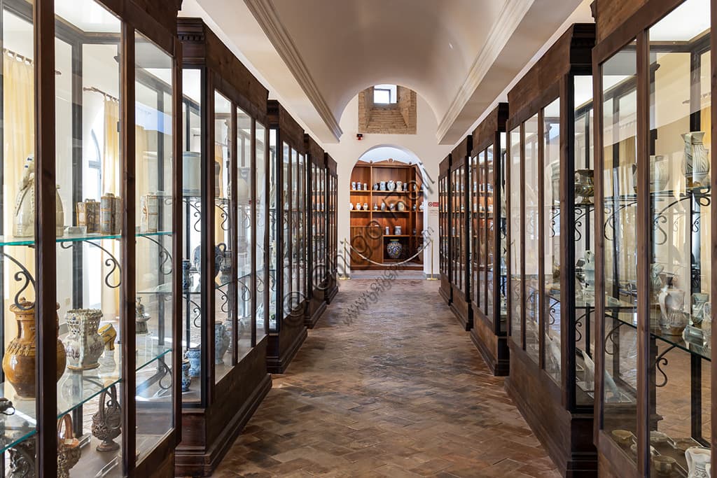 Interior view of the Deruta Ceramics Museum in Umbria with glass display cases for ceramic artifacts