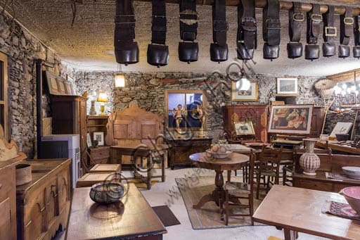 Interior of the antique shop in Bormio featuring Valtellina antique wooden furniture.