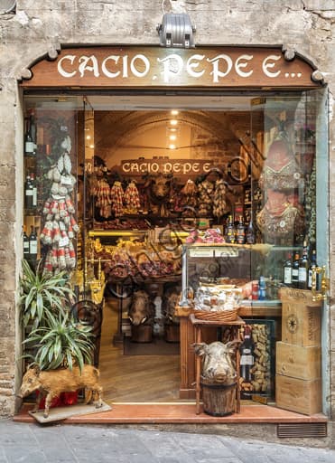 Inside the Cacio, pepe e... shop in Assisi with display of Umbrian cheeses, cured meats and regional typical products