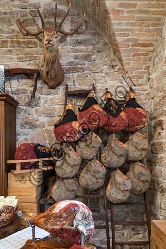 Inside of the Cacio, pepe e... shop in Assisi with display of whole Umbrian dry cured hams