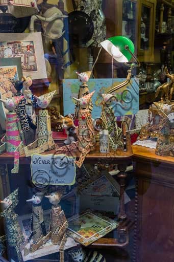 Shop window of Cose dal Passato store in Florence's Sdrucciolo de' Pitti with collection of paper Pinocchio figures
