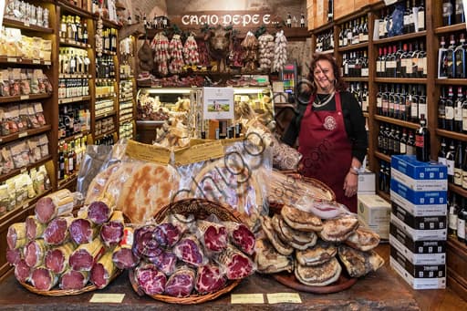 Interior of the Cacio, pepe e... shop selling typical Umbrian products in Assisi's historic centre, showcasing cured meats, cheeses and legumes
