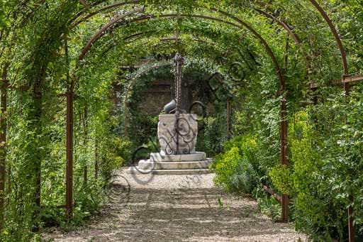 Palazzo Costabili Ferrara, garden with stone well-curb and ancient metal bell used as a bucket