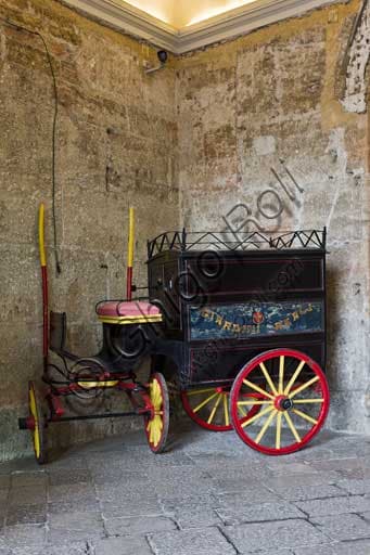 Entrance hall of the Palace of the Normans in Palermo with a small historical carriage, view towards the Maqueda courtyard