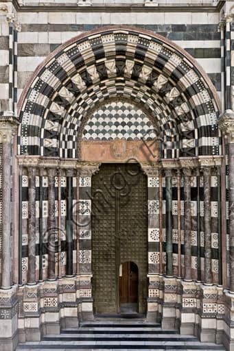 Architectural detail of the left doorway on the west façade of Genoa Cathedral, St. Lawrence Cathedral