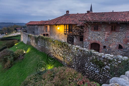 Night view of the medieval walls of the Ricetto di Candelo (Biella) overlooking the Marchesa canal, Piedmont Italy