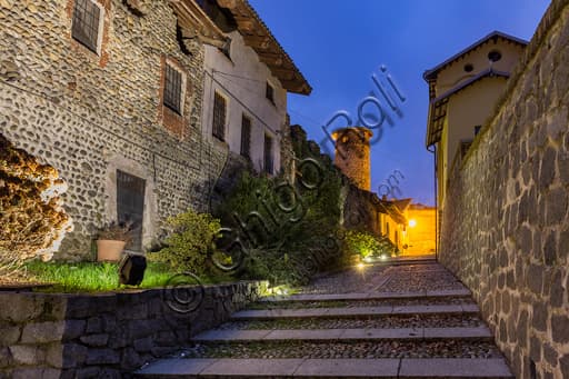 Night view of Lizza Street and the Eastern Tower in the fortified Ricetto of Candelo, Piedmont, Italy