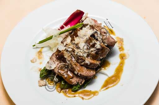 Black truffle filet with green asparagus, served at Olio & Convivium restaurant in Florence.