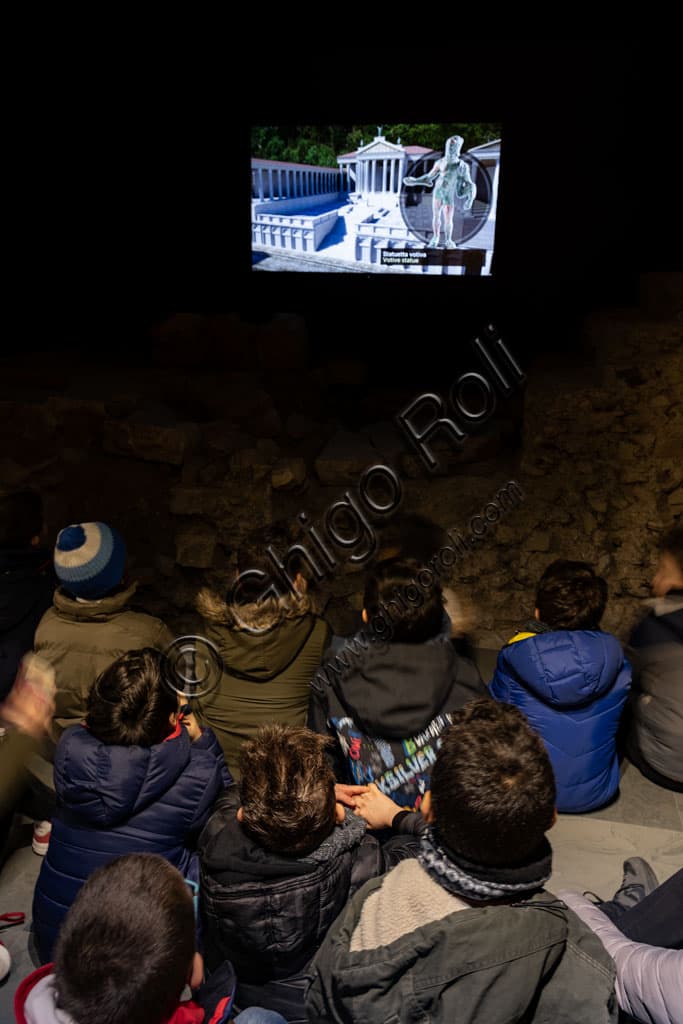 School group on an educational tour of the Capitolium archaeological area, ancient temple of Brixia, Unesco Heritage in Brescia