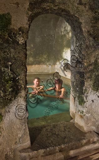 Guests in the Roman thermal pools of Bagni Vecchi, historic Bormio thermal spa, Italian Alps