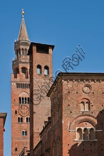 Partial view of the Torrazzo and the Town Hall Palace in Cremona from an alley in the historic center