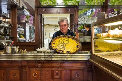 Owner of Boni Pastry Shop in Reggio Emilia presents the traditional Italian rice cake