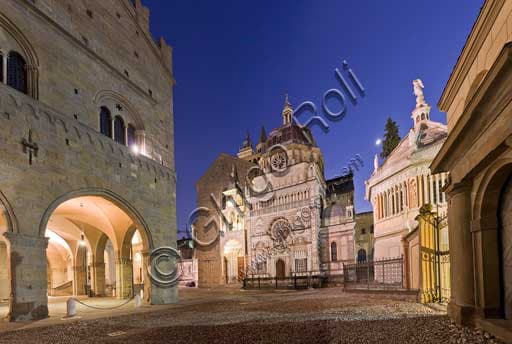 Night view of the porch of Palazzo della Ragione in Bergamo Alta with the illuminated Colleoni Chapel in the background