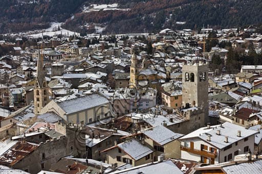Panoramic view of the town of Bormio with the Collegiate Church, Church of Sant'Ignazio, and Town Hall Tower against the mountain backdrop
